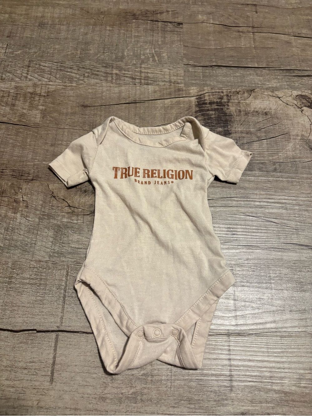 True Religion Cream/Tan Logo Baby Bodysuit